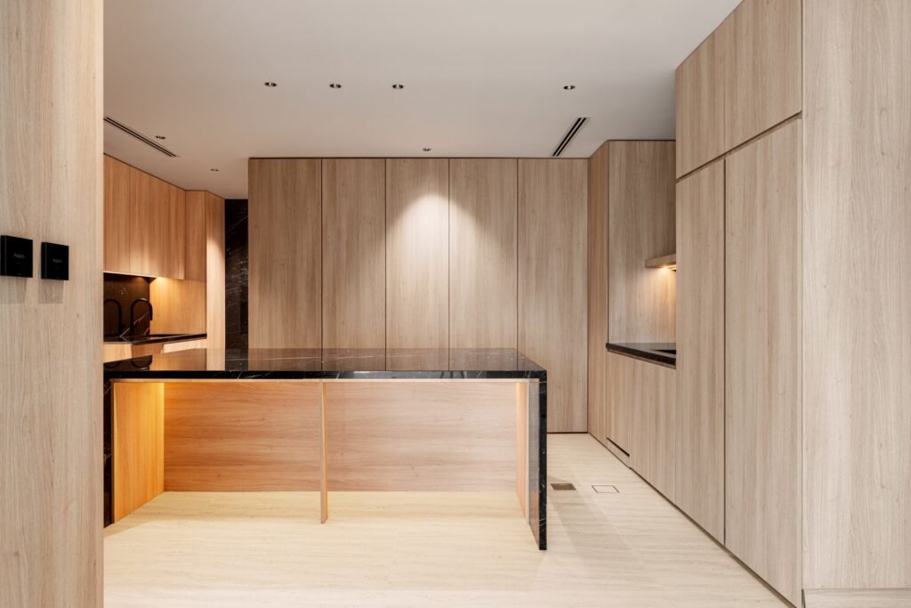 Custom luxury kitchen with warm wood cabinetry and stone countertops